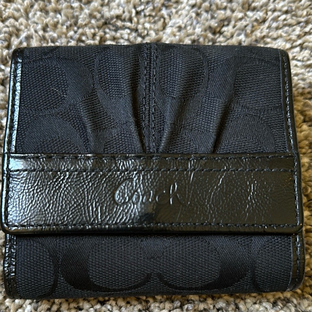 COACH - Classic "C" pattern, tri-fold wallet.